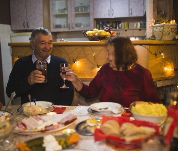 Happy senior couple in love, husband and wife toasting during family dinner and celebrate holidays at home